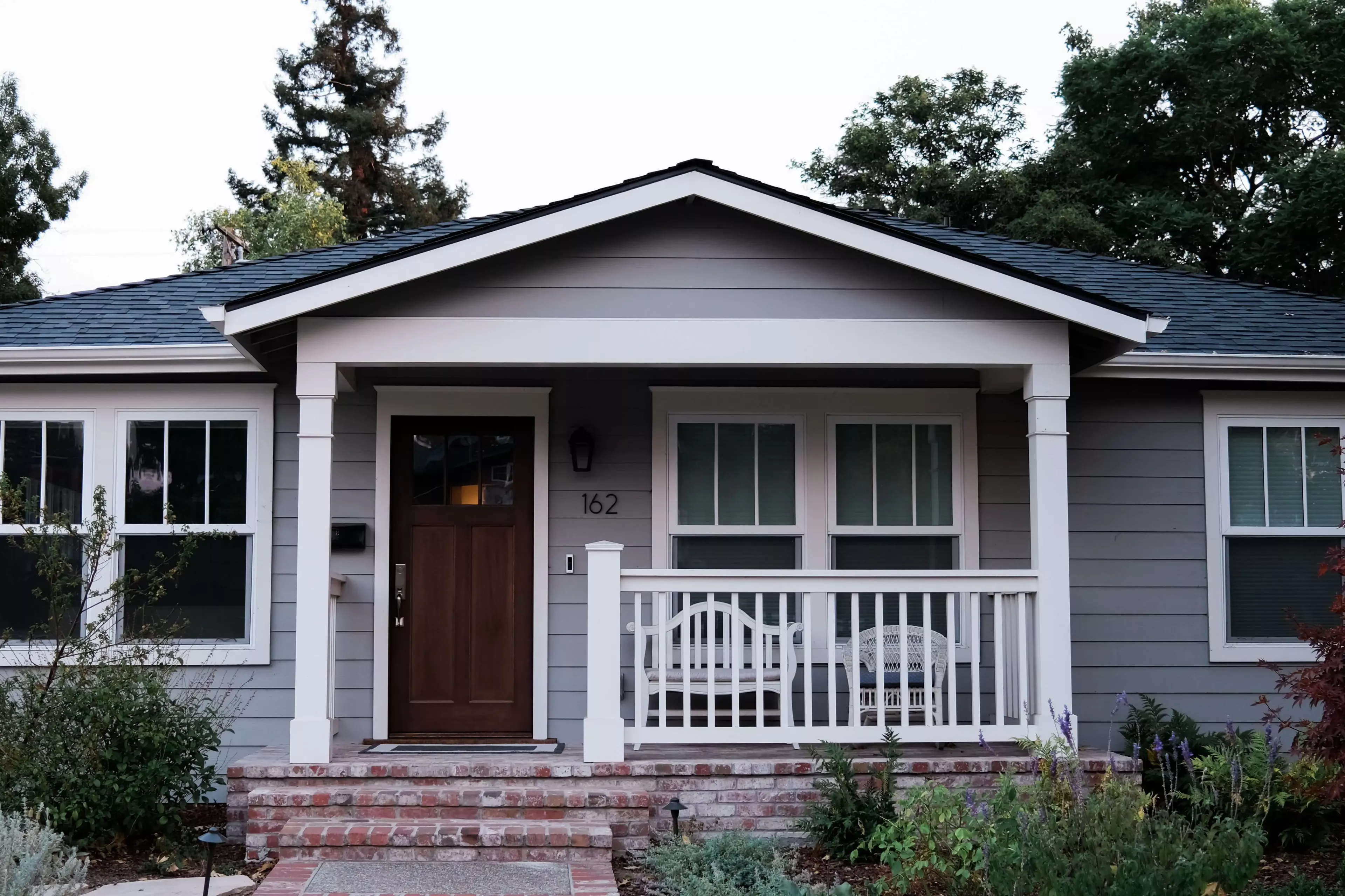 Blue House with front porch and white trim