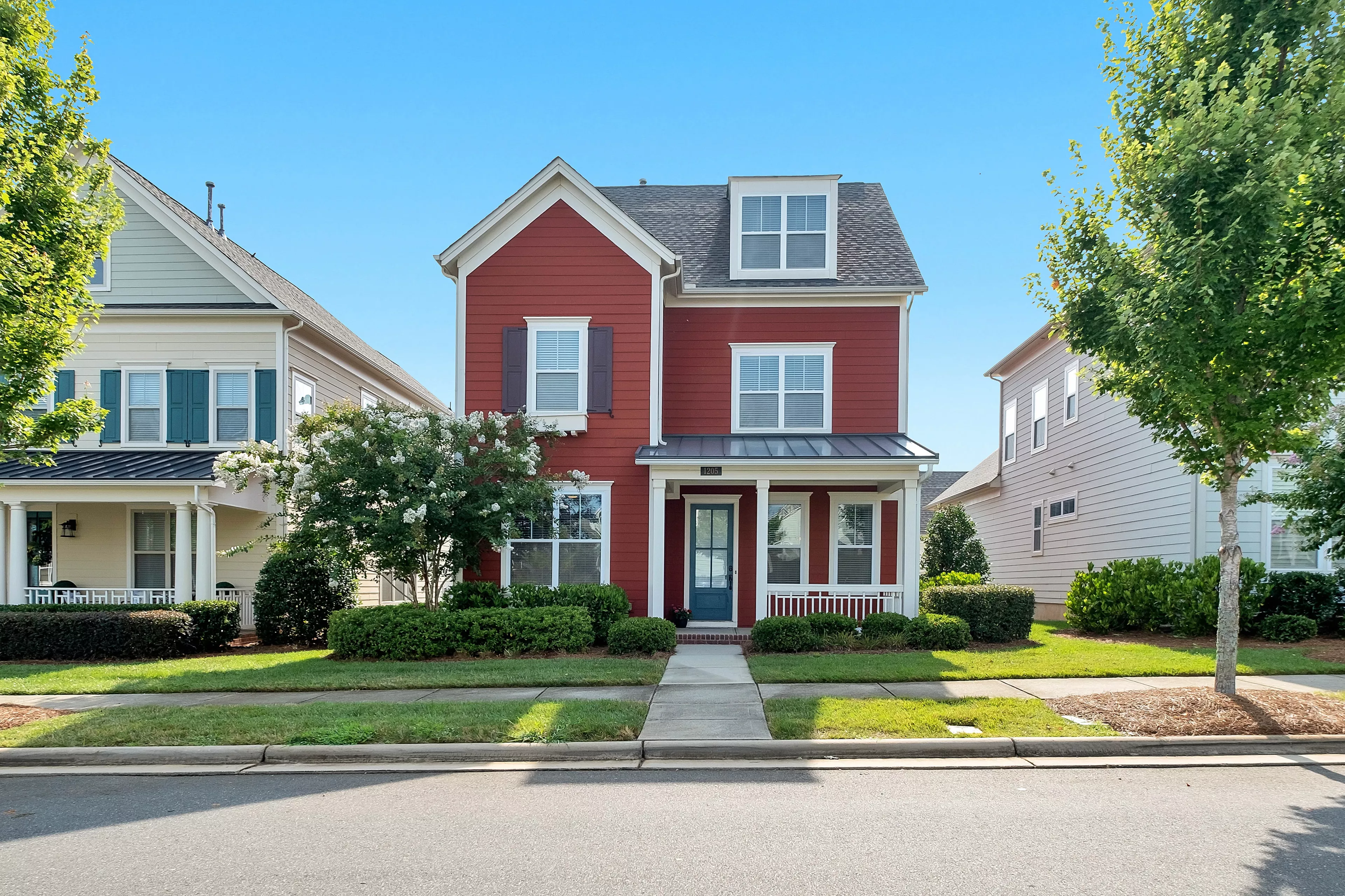 Two story red house in suburban neighborhood